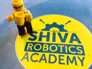Lego man next to Shiva Robotics badge